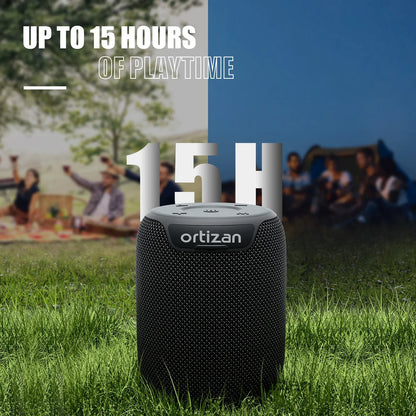 Enceinte Bluetooth Ortizan noire sur herbe, 15 heures d'autonomie, ambiance pique-nique et camping