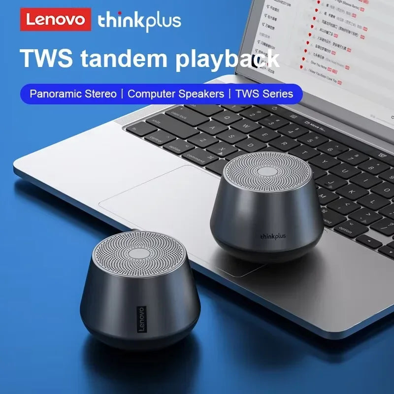 Enceintes sans fil Lenovo thinkplus TWS tandem posées sur un ordinateur portable argenté avec clavier noir