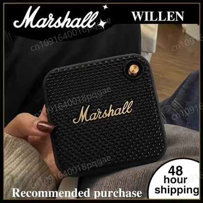 Haut-parleur portable Marshall noir texturé avec logo doré tenu en main, expédition 48 heures