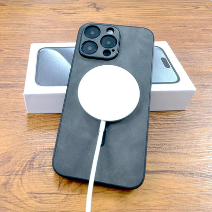 Smartphone noir avec chargeur magnétique blanc sur boîte, sur table en bois, accessoires Apple