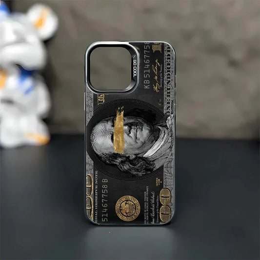 Coque de téléphone noire avec dessin billet de 100 dollars or et noir, visage barré en doré