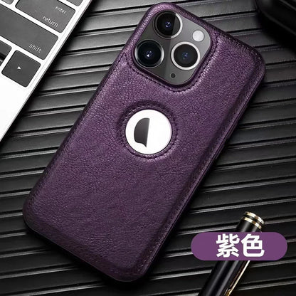 Coque de téléphone violet en cuir avec ouverture circulaire pour logo, posée près d'un clavier et d'un stylo noir